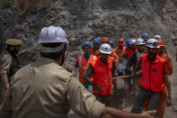 Rescue workers carry the body of a victim at the site of a collapsed tunnel in Ramban district, south of Srinagar, Indian controlled Kashmir, Friday, May 20, 2022. An official in Indian-controlled Kashmir said Friday that 10 workers were trapped after part of a road tunnel collapsed in the Himalayan region. (AP Photo/Dar Yasin)