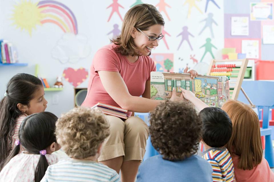 <p>Getty</p> Stock photo of a woman teaching children