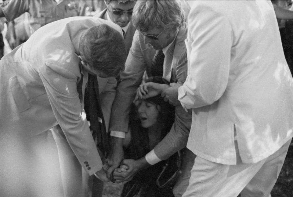 FILE- In this Sept. 5, 1975 file photo, U.S. Secret Service agents put handcuffs on Lynette "Squeaky" Fromme after she pointed at President Gerald Ford, in Sacramento, Calif. Nearly 40 years after the former Manson family member pointed a gun at President Gerald Ford, the audiotape from her pretrial psychiatric examination has been made public. (AP Photo/File)