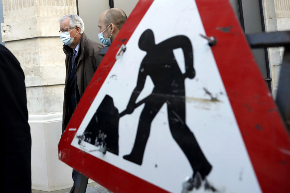 EU Chief Negotiator Michel Barnier walks with his team to attend Brexit trade negotiations at a conference centre, in London, Tuesday, Dec. 1, 2020. Teams from Britain and the European Union are continuing face-to-face talks on a post-Brexit trade deal with little time remaining. (AP Photo/Matt Dunham)