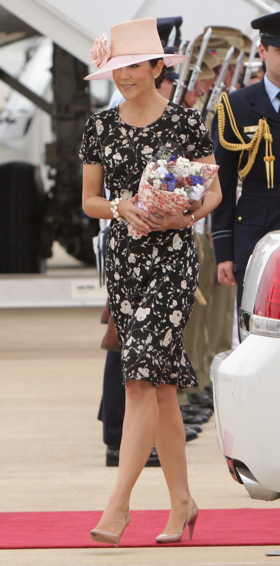 crown princess mary wearing floral dress and pink hat