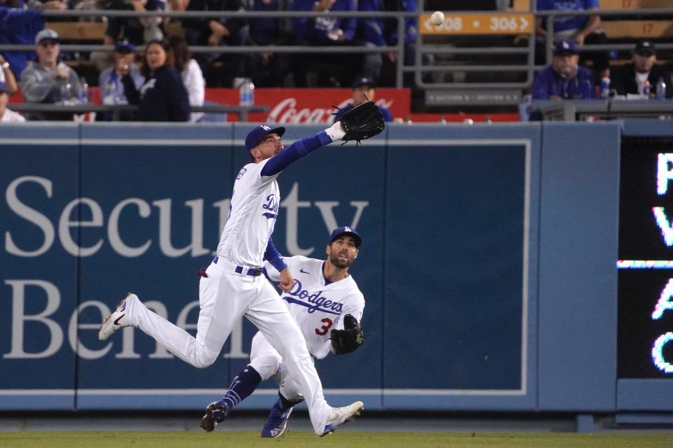 Los Angeles Dodgers center fielder Cody Bellinger, left, makes a catch on a ball hit by Cleveland Guardians' Owen Miller as right fielder Chris Taylor backs him up during the Ninth inning of a baseball game Friday, June 17, 2022, in Los Angeles. (AP Photo/Mark J. Terrill)