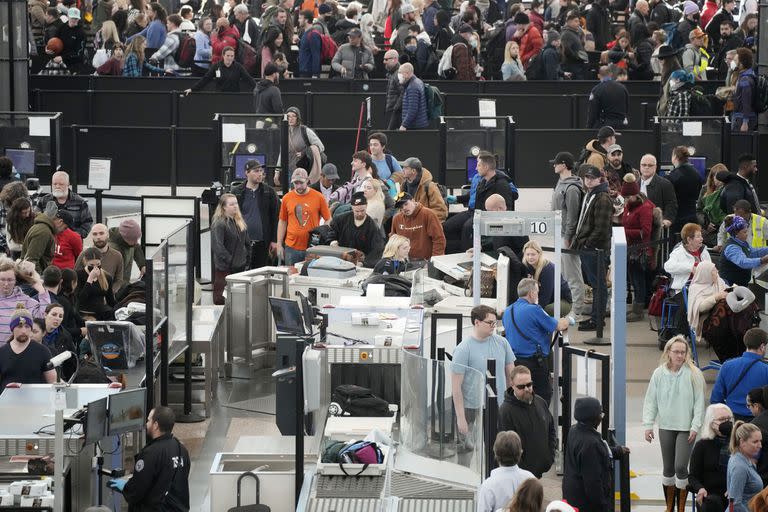 Los viajeros hacen cola para pasar por el punto de control de seguridad del sur en el Aeropuerto Internacional de Denver después de que una tormenta invernal arrasara el país acumulando nieve combinada con el frío del Ártico, lo que creó el caos para las personas que intentaban llegar a sus destinos antes de las vacaciones de Navidad, el viernes 23 de diciembre.