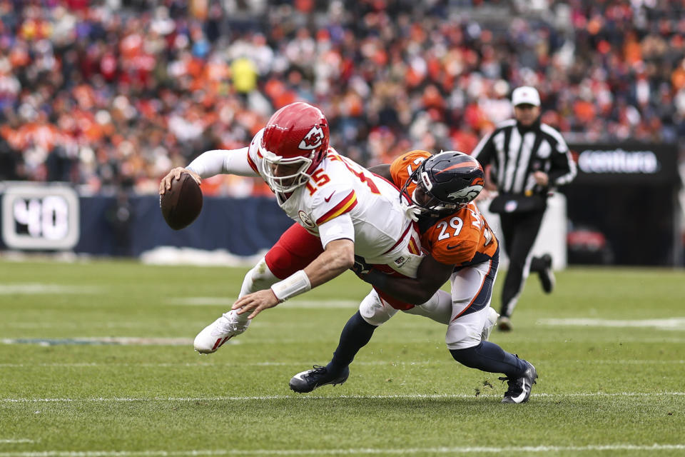 DENVER, COLORADO - OCTOBER 29: Patrick Mahomes #15 of the Kansas City Chiefs dives against Ja'Quan McMillian #29 of the Denver Broncos during an NFL football game between the Denver Broncos and the Kansas City Chiefs at Empower Field At Mile High on October 29, 2023 in Denver, Colorado. (Photo by Michael Owens/Getty Images)