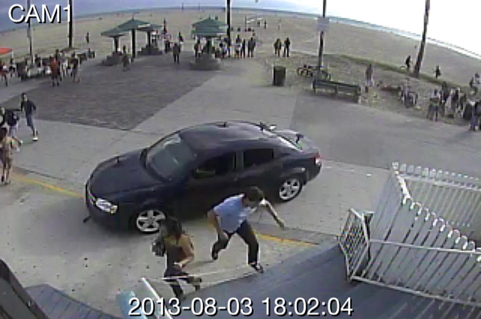 In this still frame made from security camera footage from Snapchat, Inc. headquarters, pedestrians scatter as a car drives through a packed afternoon crowd along the Venice Beach boardwalk in Los Angeles, Saturday, Aug. 3, 2013. A driver plowed into crowds at the Venice Beach boardwalk in a seemingly intentional hit-and-run that killed a woman and injured 11 others. (Snapchat Inc./AP)