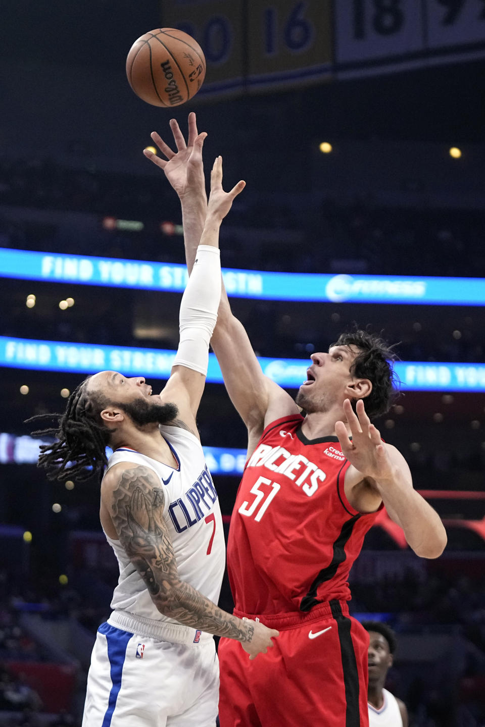 Houston Rockets center Boban Marjanovic, right, shoots as Los Angeles Clippers guard Amir Coffey defends during the second half of an NBA basketball game Sunday, April 14, 2024, in Los Angeles. (AP Photo/Mark J. Terrill)