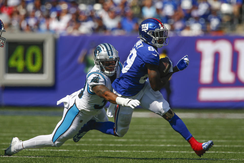 New York Giants' Kadarius Toney, right, tries to avoid a tackle by Carolina Panthers' Myles Hartsfield during the first half an NFL football game, Sunday, Sept. 18, 2022, in East Rutherford, N.J. (AP Photo/John Munson)