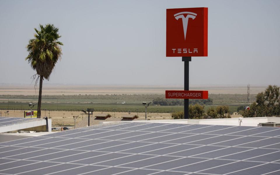 A Tesla supercharger station in Kettleman City, California, last month. The company's solar panels had been installed in more than 240 Walmart stores, with Tesla taking responsibility for maintaining the equipment, Walmart said     - Bloomberg