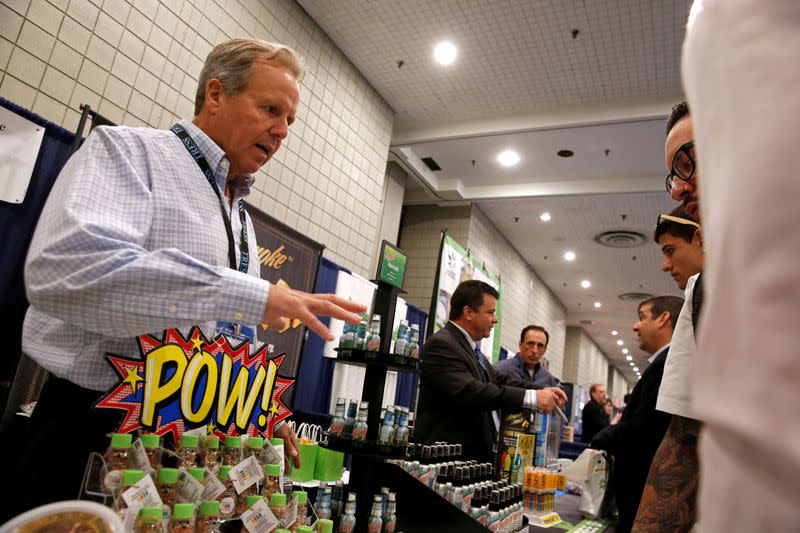 FILE PHOTO: A representative of a cannabis-based product company interacts with attendees during the Cannabis World Congress & Business Exposition in New York City