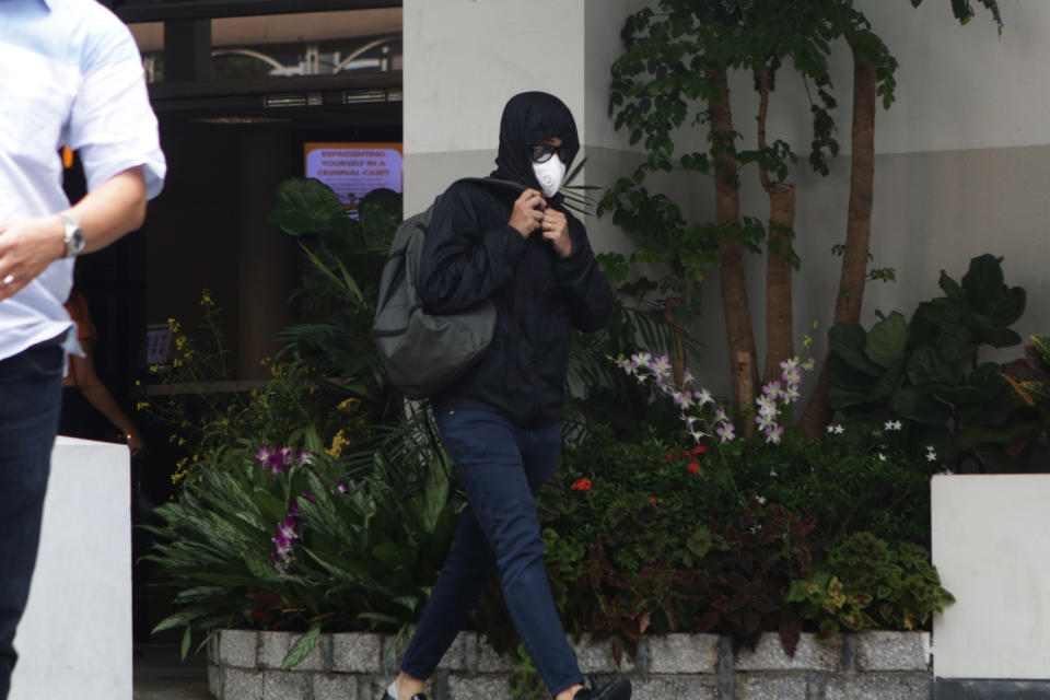 One of the disguised men seen leaving the State Courts on Wednesday (31 October) morning following the charging of SAF Captain Tan Baoshu. (PHOTO: Dhany Osman / Yahoo News Singapore)