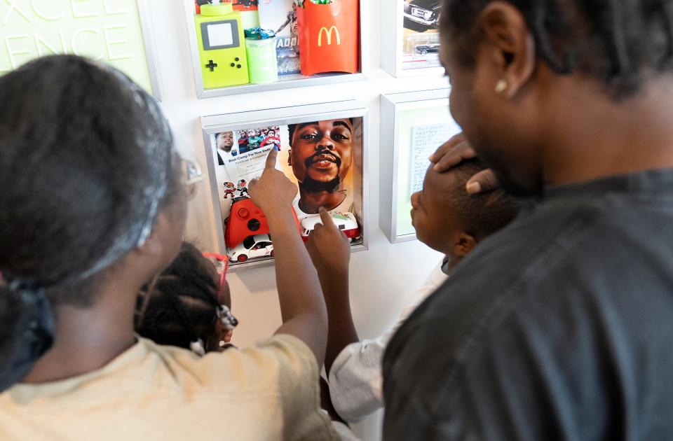 Members of DeVille Morrow's family point to details in the shadowbox showcasing his memory at the Lifeline of Ohio offices. Morrow, who passed away on Aug. 9, 2021, donated his organs through the nonprofit procurement organization following his death.