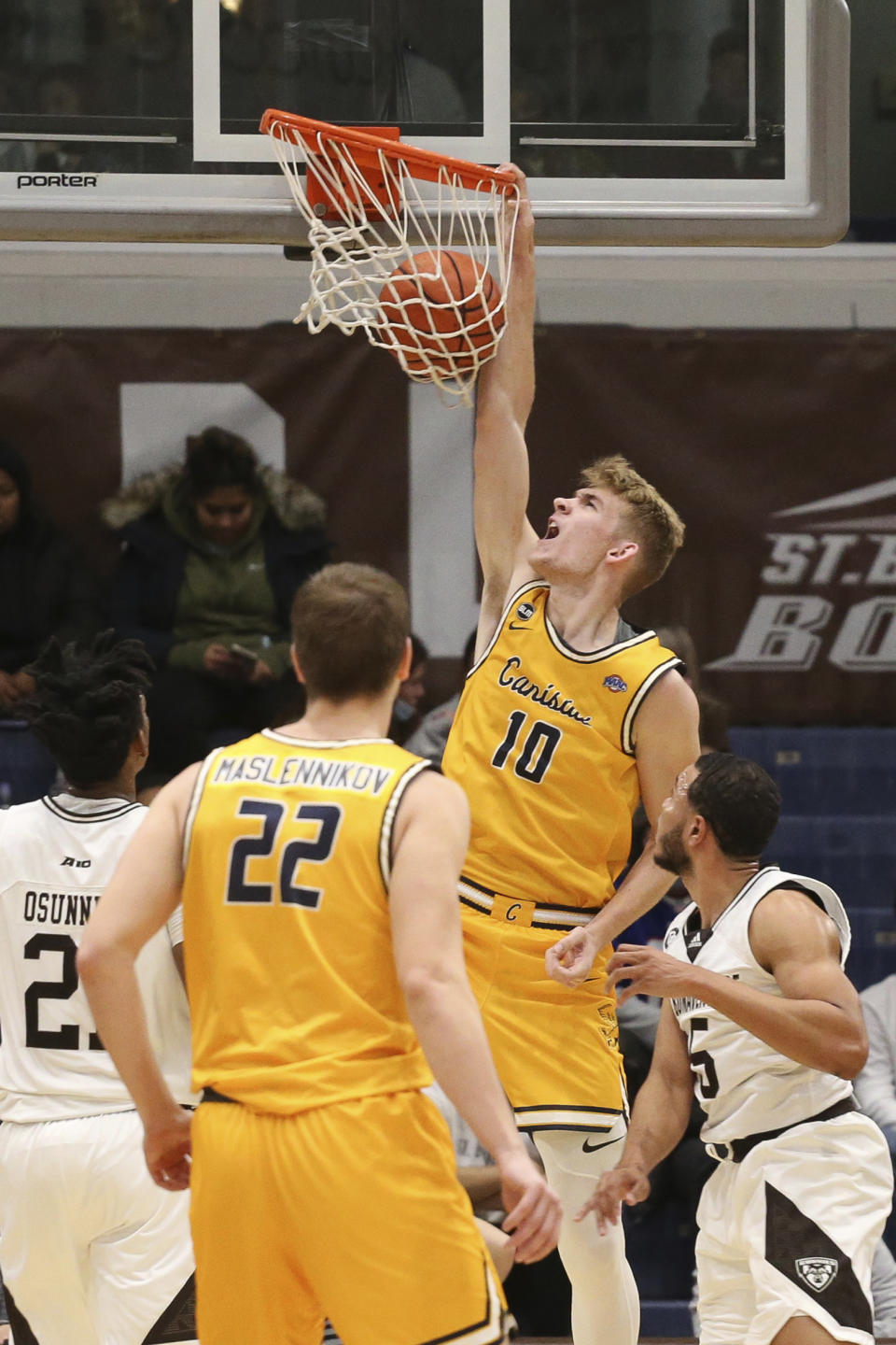 Canisius forward Jacco Fritz (10) dunks and his fouled by St. Bonaventure guard Jaren Holmes (5) during the first half of an NCAA college basketball game Sunday, Nov. 14, 2021, in Olean, N.Y. (AP Photo/Joshua Bessex)