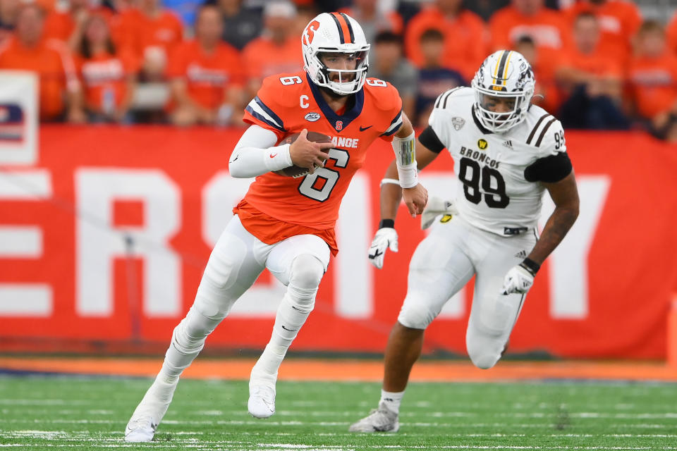 Sep 9, 2023; Syracuse, New York, USA; Syracuse Orange quarterback Garrett Schrader (6) runs with the ball as Western Michigan Broncos defensive lineman Marshawn Kneeland (99) defends during the first half at the JMA Wireless Dome. Mandatory Credit: Rich Barnes-USA TODAY Sports