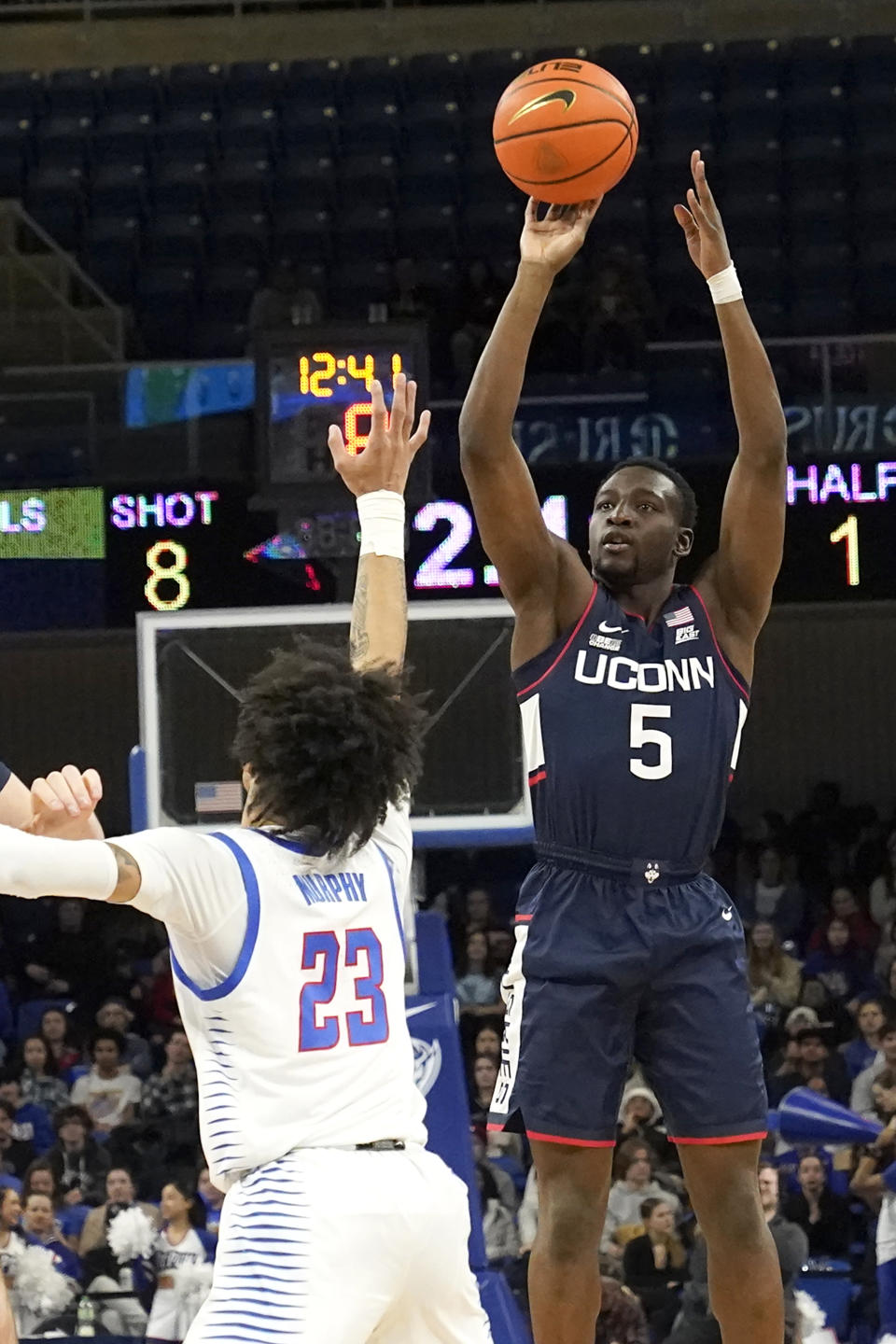 Connecticut's Hassan Diarra (5) shoots over DePaul's Caleb Murphy during the first half of an NCAA college basketball game Tuesday, Jan. 31, 2023, in Chicago. (AP Photo/Charles Rex Arbogast)