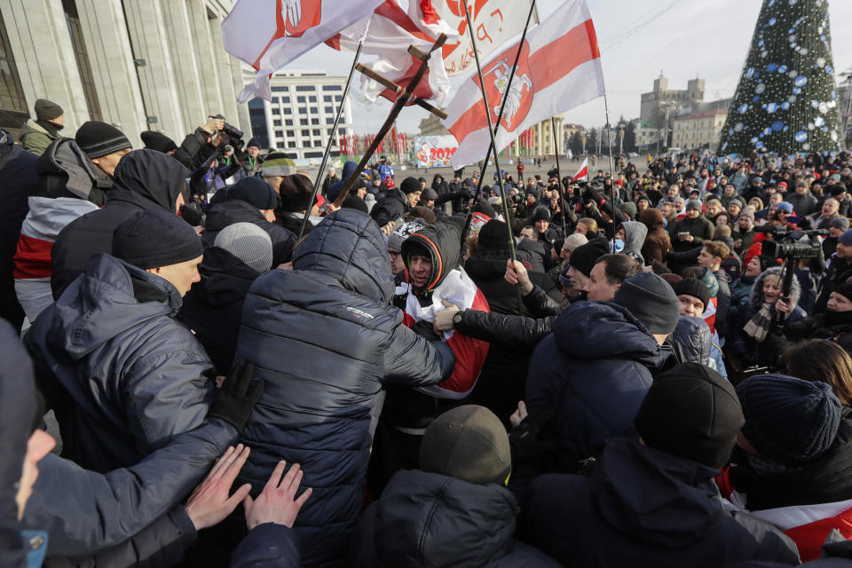 CAPTION CORRECTS PRO GOVERNMENT PEOPLE TO PLAIN CLOTHED POLICE Protesters argue with plain clothed police, during a rally in downtown Minsk, Belarus, Saturday, Dec. 7, 2019. Several hundreds demonstrators gathered to protest against closer integration with Russia. (AP Photo/Sergei Grits)