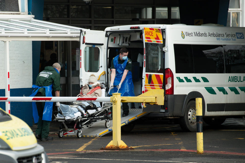 Ambulance crews transport a patient at City Hospital in Birmingham. West Midlands Ambulance Service has experienced its busiest day on record as hospitals struggle to cope with an influx of coronavirus cases. On Monday, the service dealt with 5,383 calls in 24 hours. The previous record was 5,001 calls in March 2018. (Photo by Jacob King/PA Images via Getty Images)