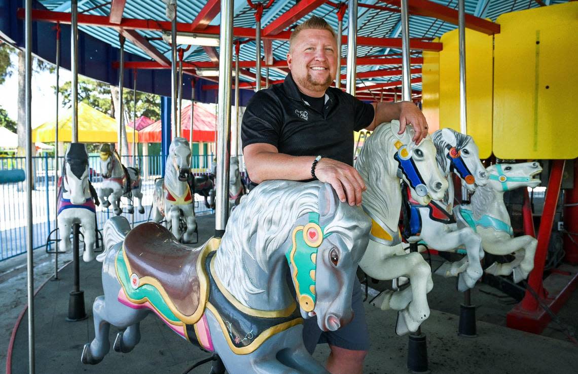 Davey Helm of Helm and Sons Amusements stands among the horses on the carousel which he is having restored at Playland in Roeding Park on Wednesday, April 19, 2023.