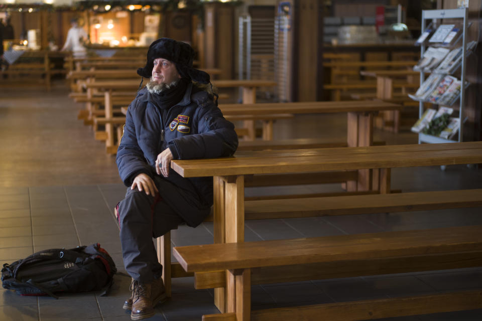 Homeless man Kaspars Breidaks from Latvia poses for a portrait during an interview with the Associated Press in guest room of Berlin's biggest restaurant Hofbraeu Berlin, in Berlin, Germany, Thursday, Dec. 17, 2020. The restaurant which had to closed due to the corona pandemic has opened its doors for homeless people. Starting this week the Hofbraeu Berlin offers free meals, a place to warm up and counseling for up to 150 homeless people per day. (AP Photo/Markus Schreiber)