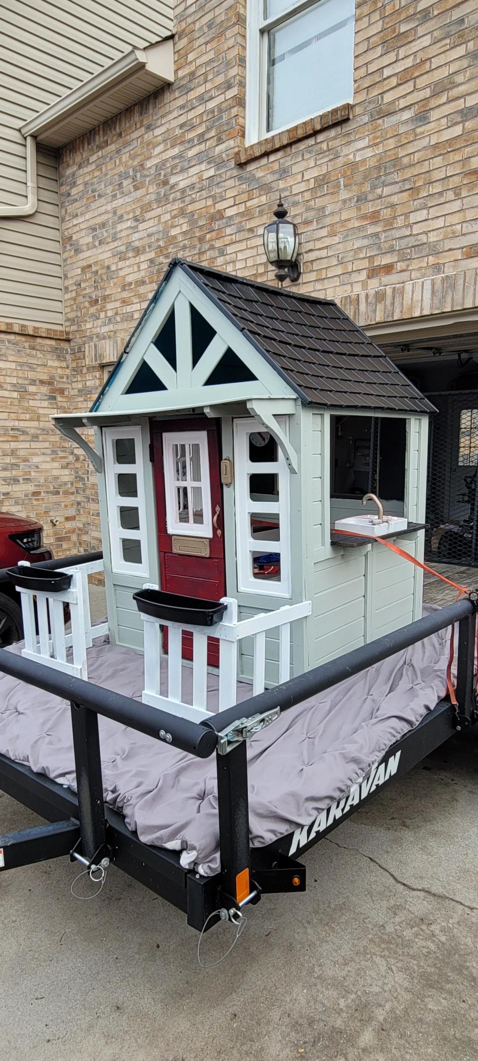 Josh Turner, Alicia's husband, bought this playhouse, fixed it up, and used it as the centerpiece of the family's float in the Oak Ridge Christmas Parade. He sold the playhouse and donated the money to St. Jude Children's Research Hospital.