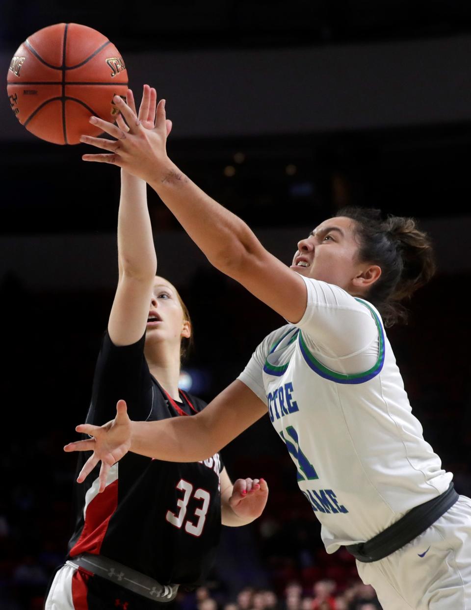 Green Bay Notre Dame's Sydney Whitehouse, right, puts up a shot against Pewaukee during the WIAA Division 2 state championship game March 9 at the Resch Center in Ashwaubenon.