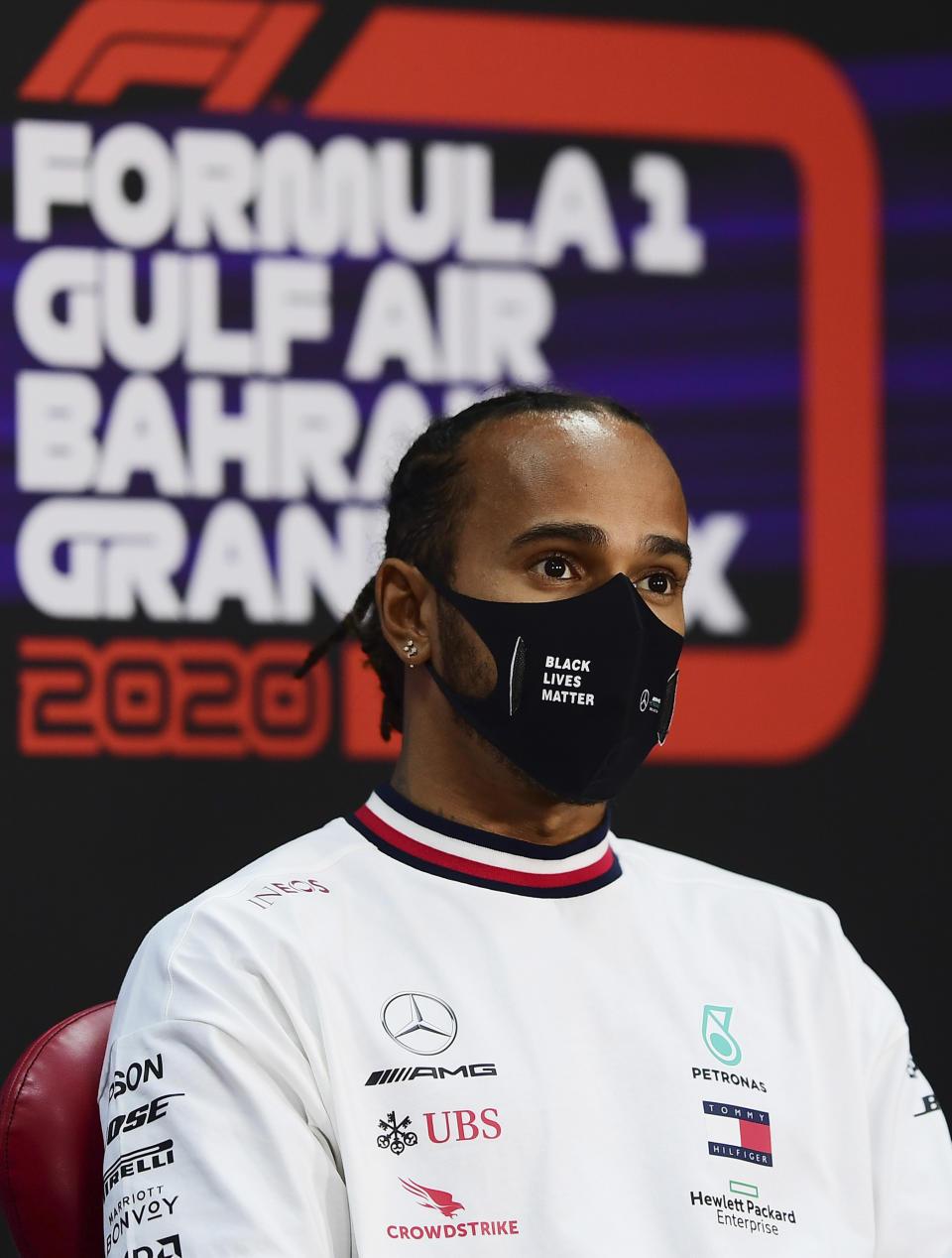 FILE - In this Thursday, Nov. 26, 2020 file photo Mercedes driver Lewis Hamilton of Britain participates in a media conference prior to the Bahrain Formula One Grand Prix at the International Circuit in Sakhir, Bahrain. The Bahrain Formula One Grand Prix will take place on Sunday. World champion Lewis Hamilton tested positive for COVID-19 and will miss the Sakhir Grand Prix this weekend, his Mercedes-AMG Petronas F1 Team said Tuesday Dec. 1, 2020. (Mario Renzi, Pool via AP, File)