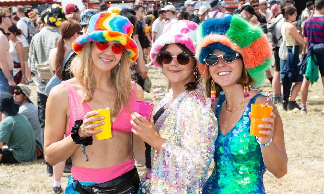 <span>Hot-headed … three festivalgoers brave the sun in furry hats.</span><span>Photograph: Richard Isaac/Rex/Shutterstock</span>