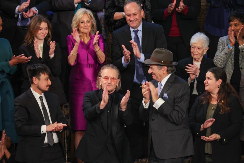 Brandon Tsay, hero of the Monterey, California, shooting, Irish singer-songwriter Bono, Paul Pelosi, husband of Rep. Nancy Pelosi (D-CA), and Ukrainian Ambassador to the U.S. Oksana Markarova, applaud during U.S. President Joe Biden's State of the Union address in the House Chambers of the U.S. Capitol on February 07, 2023 in Washington, DC. The speech marks Biden's first address to the new Republican-controlled House.