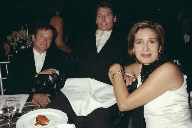 <p>Richard Corkery/NY Daily News Archive via Getty</p> Robin Williams (seated, left) joins Christopher Reeve and his wife Dana at the American Paralysis Association dinner at the Waldorf-Astoria