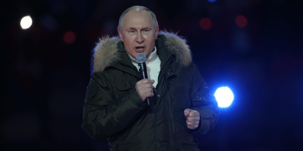 Russian President Vladimir Putin speaking into a microphone.