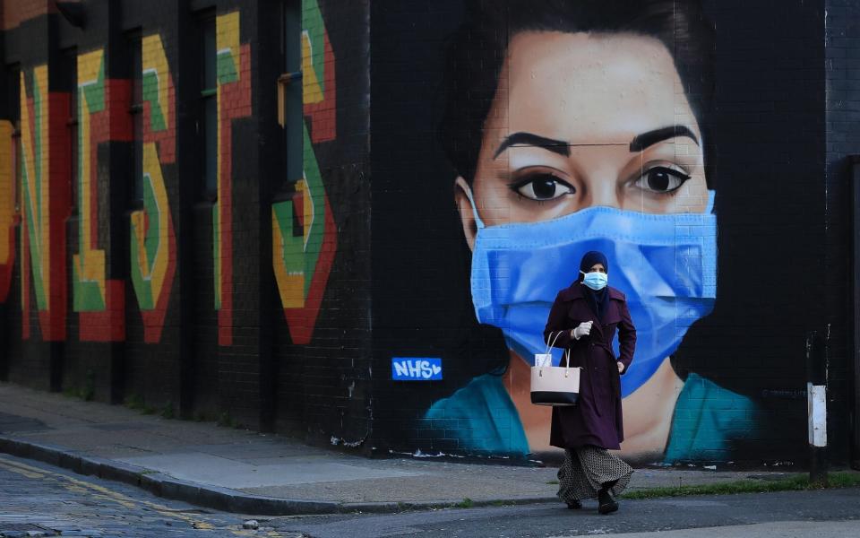a woman in a face mask - Andrew Redington/Getty Images