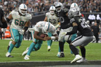 Miami Dolphins quarterback Jacoby Brissett (14) runs in for a touchdown against the Las Vegas Raiders during the second half of an NFL football game, Sunday, Sept. 26, 2021, in Las Vegas. (AP Photo/David Becker)