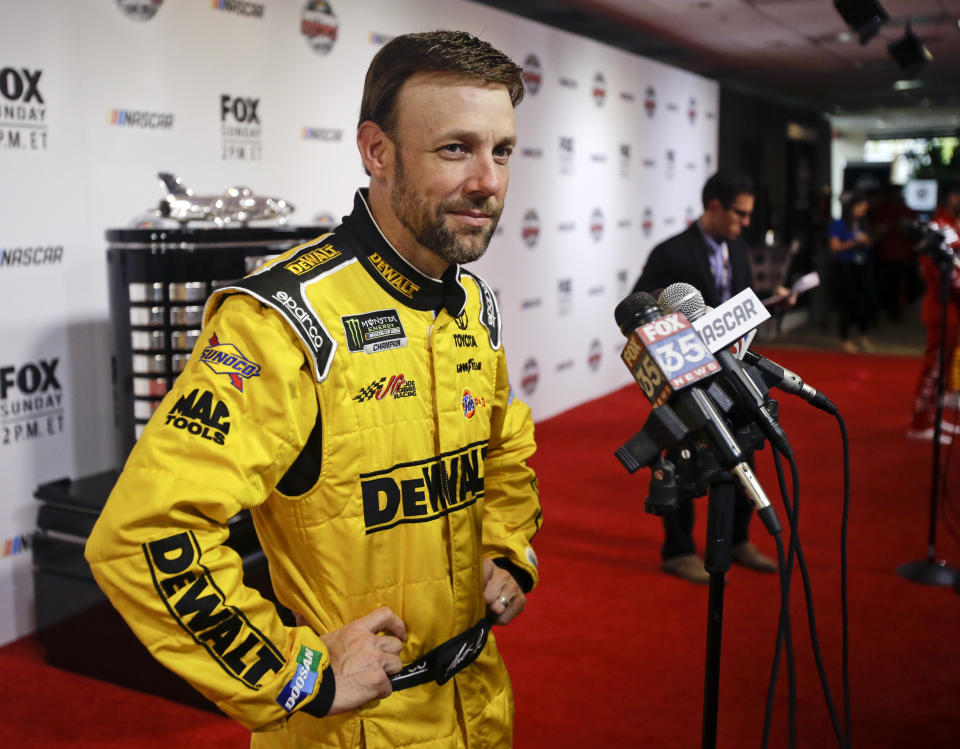 FILE - In this Feb. 22, 2017, file photo, Matt Kenseth answers questions during NASCAR Daytona 500 media day at Daytona International Speedway in Daytona Beach, Fla. Former NASCAR champion Matt Kenseth will once again come out of retirement to compete for Chip Ganassi Racing as the replacement for fired driver Kyle Larson. Larson lost his job two weeks ago for using a racial slur while competing in a virtual race. (AP Photo/John Raoux, File)