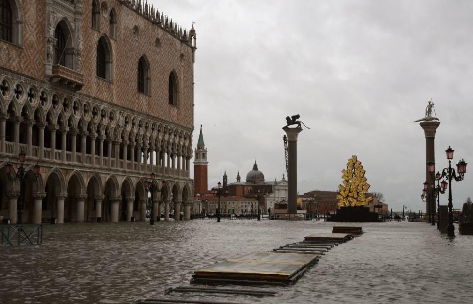 Flooding at St Mark's Square by the Doge's Palace and a luminous Christmas Tree installation by Italian artist Fabrizio Plessi.