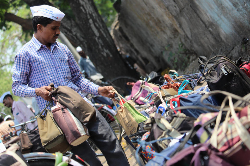 A lunchbox delivery man or Dabbawala gets ready to deliver the lunches to the workplace in Mumbai, India on 26 April 2019. (Photo by Himanshu Bhatt/NurPhoto via Getty Images)