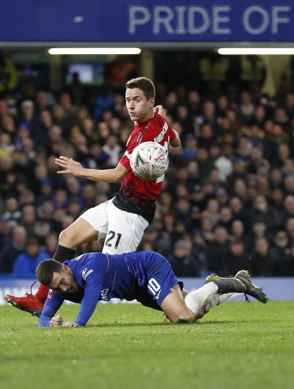 Manchester United's Ander Herrera, rear, fouls Chelsea's Eden Hazard during the English FA Cup fifth round soccer match between Chelsea and Manchester United at Stamford Bridge stadium in London, Monday, Feb. 18, 2019. (AP Photo/Alastair Grant)