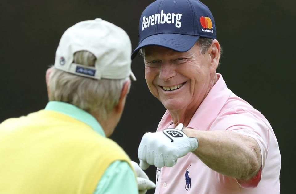 Two-time Masters champion Tom Watson, right, gets a fist bump from six-time Masters champion Jack Nicklaus after sinking a birdie putt on the fourth hole during the Par-3 Contest at the Masters golf tournament at Augusta National Golf Club in Augusta, Ga., Wednesday, April 4, 2018. (Curtis Compton/Atlanta Journal-Constitution via AP)