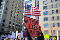<p>A demonstrator holds up a sign and U.S. flag during the “Not My President’s Day” rally at Central Park West in New York City on Feb. 20, 2017. (Gordon Donovan/Yahoo News) </p>