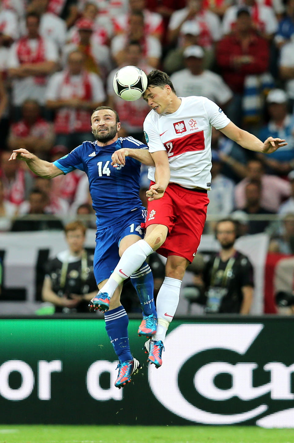 WARSAW, POLAND - JUNE 08: Dimitris Salpigidis of Greece and Sebastian Boenisch of Poland go up and head the ball during the UEFA EURO 2012 group A match between Poland and Greece at National Stadium on June 8, 2012 in Warsaw, Poland. (Photo by Alex Grimm/Getty Images)