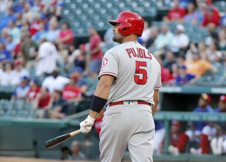 Los Angeles Angels' Albert Pujols watches his three-run home run ball off a pitch from Texas Rangers' Kolby Allard in the first inning of baseball game in Arlington, Texas, Monday, Aug. 19, 2019. (AP Photo/Tony Gutierrez)