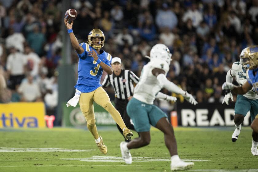 UCLA quarterback Dante Moore throws a pass against Coastal Carolina