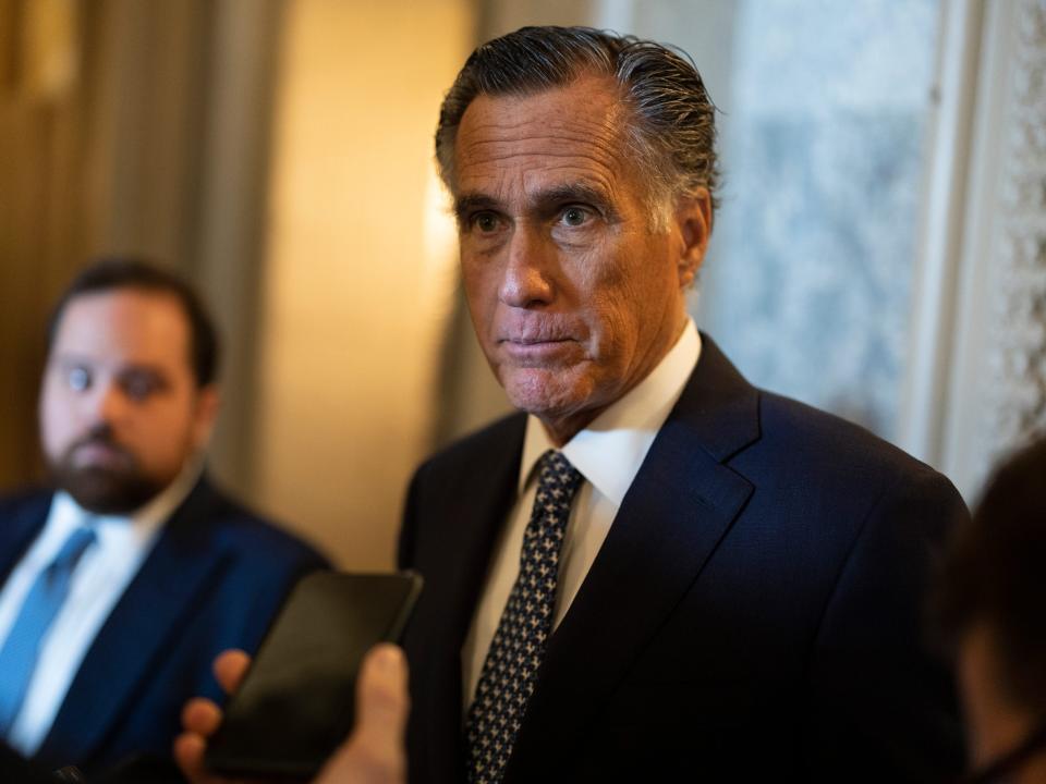 Sen. Mitt Romney speaking to reporters in the capitol building