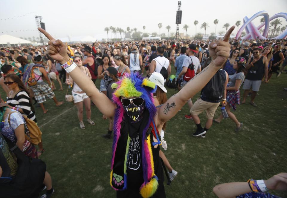 A concertgoer dances during the performance by Kid Cudi at the Coachella Valley Music and Arts Festival in Indio