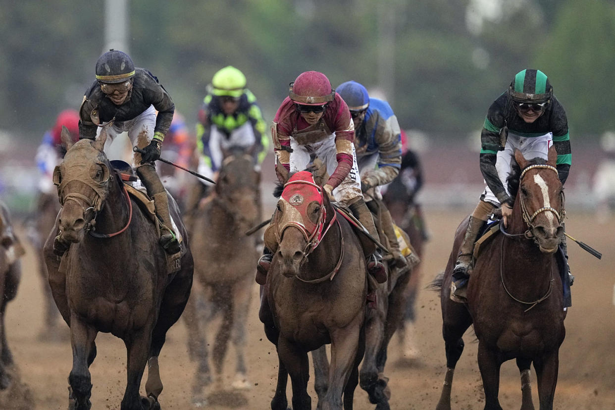 Mystik Dan and rider Brian Hernandez race to the line and win the 150th running of the Kentucky Derby horse race (Brynn Anderson / AP)