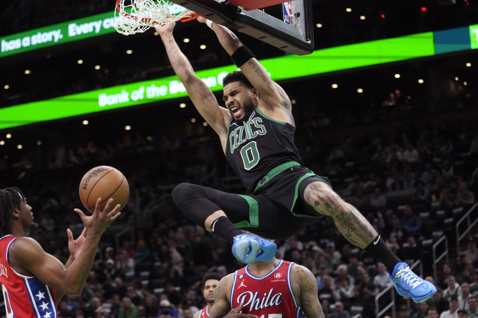 Boston Celtics forward Jayson Tatum (0) slams a dunk against the Philadelphia 76ers during the first half of Game 1 in the NBA basketball Eastern Conference semifinals playoff series, Monday, May 1, 2023, in Boston. (AP Photo/Charles Krupa)