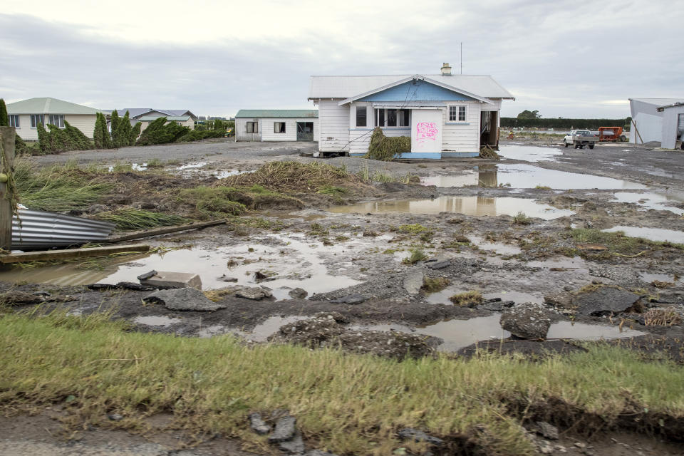 A house is surrounded by debris and floodwater in Hawkes Bay, New Zealand, Friday, Feb. 17, 2023. Cyclone Gabrielle struck the country's north on Monday and has brought more destruction to this nation of 5 million than any weather event in decades. (Mark Mitchell/New Zealand Herald via AP)