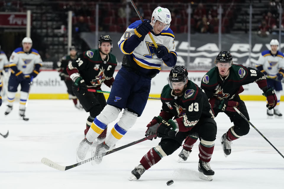 Arizona Coyotes right wing Conor Garland (83) shields St. Louis Blues center Oskar Sundqvist (70) from the puck in the first period during an NHL hockey game, Monday, Feb. 15, 2021, in Glendale, Ariz. (AP Photo/Rick Scuteri)
