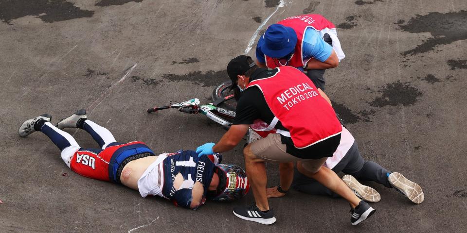 Connor Fields lays on the ground and is treated by medical staff after a crash at the Tokyo Olympics.