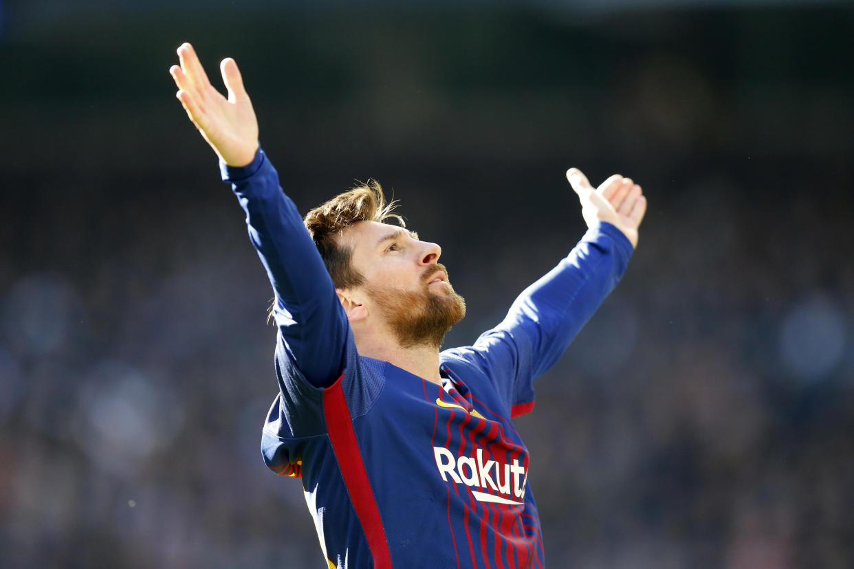 Lionel Messi celebrates in front of Real Madrid fans after the second Barcelona goal of Saturday’s 3-0 Clasico win. (Getty)