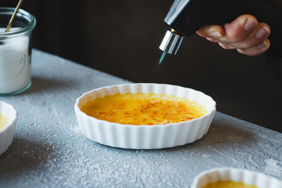 someone blow torching a creme brûlée