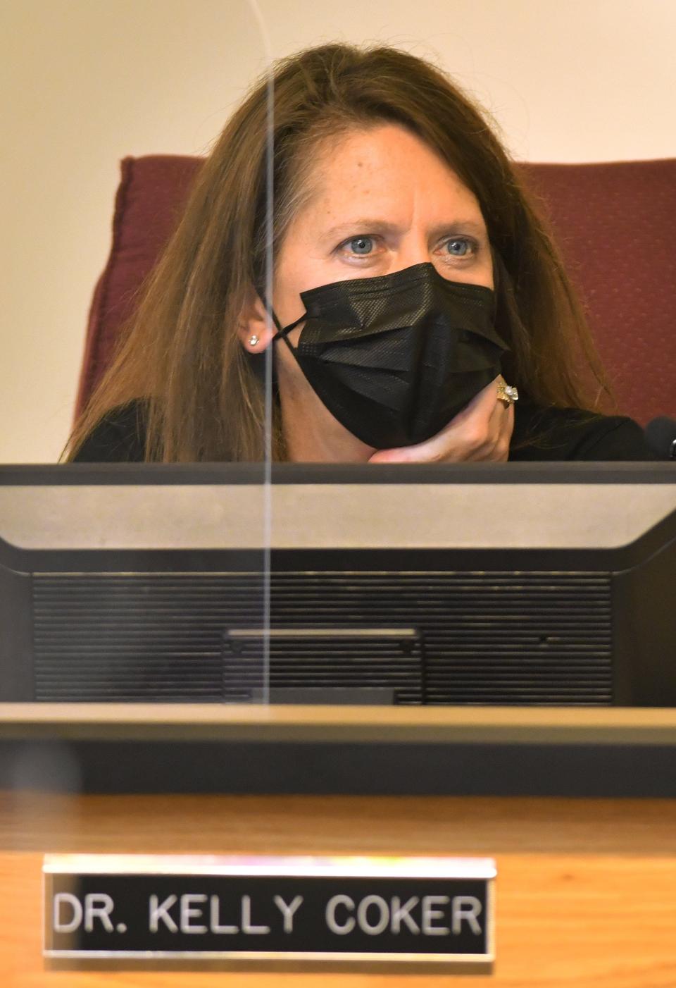 School board member Kelly Coker listens to public comments during a school board meeting.